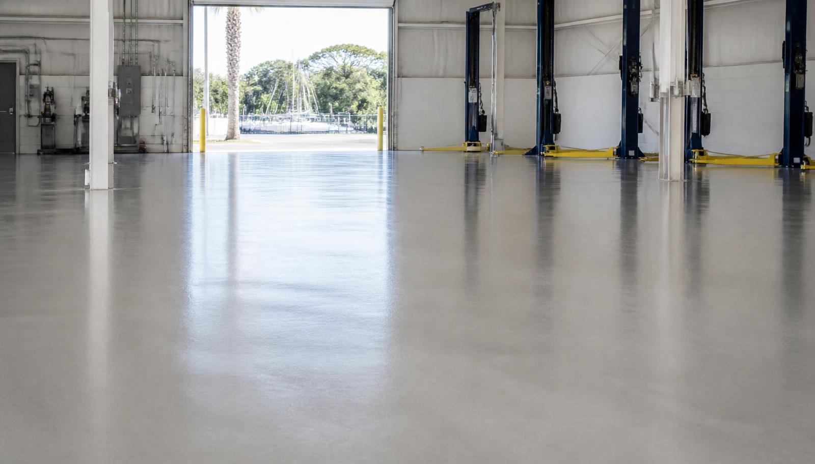 Seamless light gray commercial epoxy floor inside a service bay near Myrtle Beach